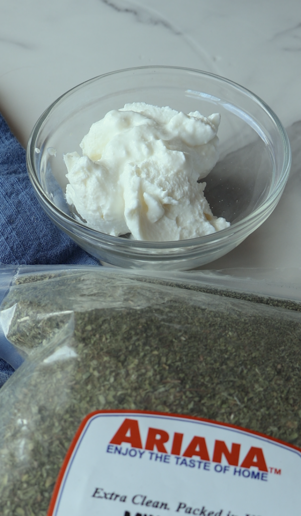 a garlicky yogurt mix with dried mint over it